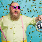 Portrait of his he nice attractive cheerful cheery glad bearded mature guy holding in hand disco ball having fun free time isolated over bright vivid shine vibrant blue color background